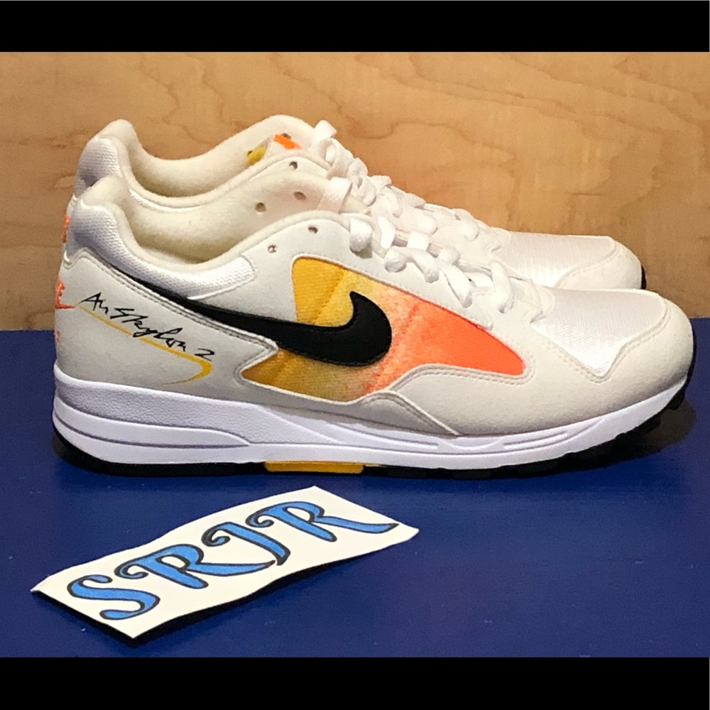 Nike Women’s White Sneakers with Black Swoosh and Orange/Yellow Accents